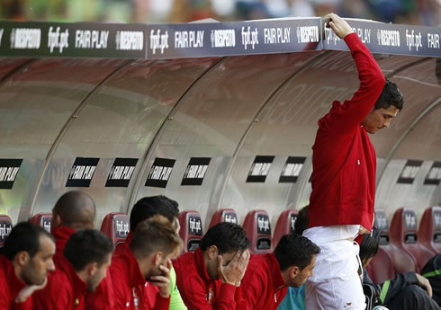 Cristiano Ronaldo stretching in Portugal's bench, after being substituted in the game against Macedonia, for the EURO 2012 preparation