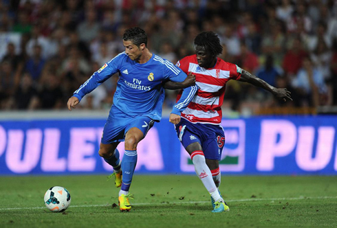 Cristiano Ronaldo being held by his arm, in a match between Granada and Real Madrid in the Spanish League 2013-14