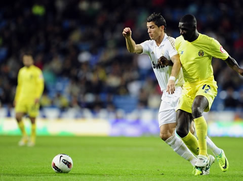 Cristiano Ronaldo uses his body to protect the ball against a Villarreal defender in La Liga 2011/2012