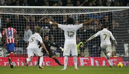 Marcelo celebrating in anticipation, as Cristiano Ronaldo takes a penalty-kick