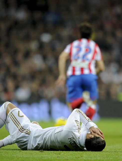 Cristiano Ronaldo on the ground with his hands covering his face, against Atletico Madrid