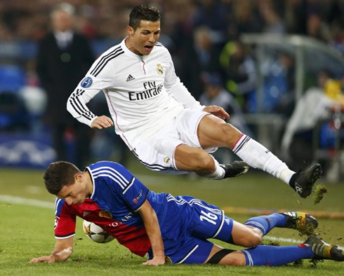 Cristiano Ronaldo escaping a harsh tackle from a Basel defender