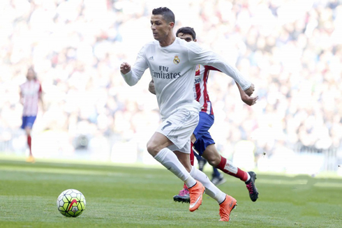 Cristiano Ronaldo running fast on a Saturday afternoon game at the Santiago Bernabéu, between Real Madrid and Atletico