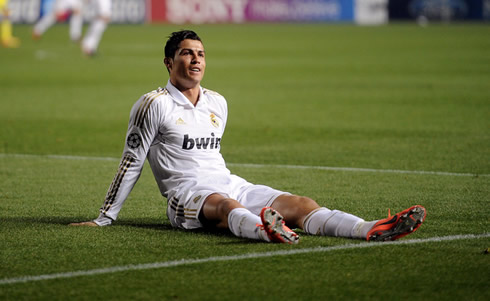 Cristiano Ronaldo sits on the pitch and smiles to the crowd in Cyprus, during a game between APOEL Nicosia and Real Madrid