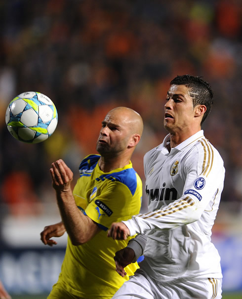 Cristiano Ronaldo fighting for the ball with a Portuguese bald defender from APOEL, Paulo Jorge