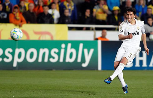 Nuri Sahin shooting a ball as he plays for Real Madrid in the UEFA Champions League, 2012 edition
