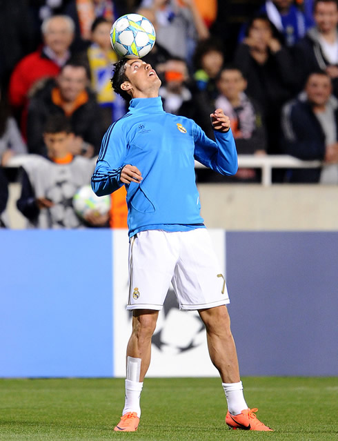 Cristiano Ronaldo holding the ball with his forehead in a UEFA Champions League warm-up relax exercise in 2012