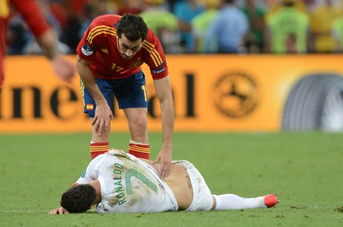 Arbeloa checking if his Real Madrid teammate, Cristiano Ronaldo, is fine or injured, as he lays down on the groun in Portugal vs Spain for the EURO 2012