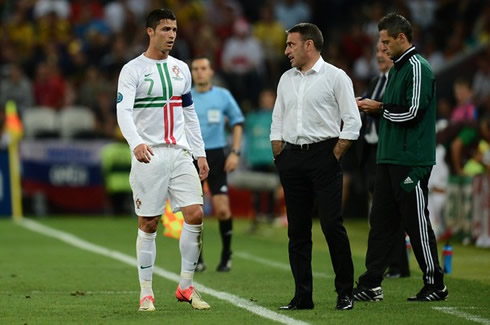 Cristiano Ronaldo walking near the sideline, in order to exchange a few words with the Portuguese National Team coach, Paulo Bento, at the EURO 2012 semi-finals against Spain