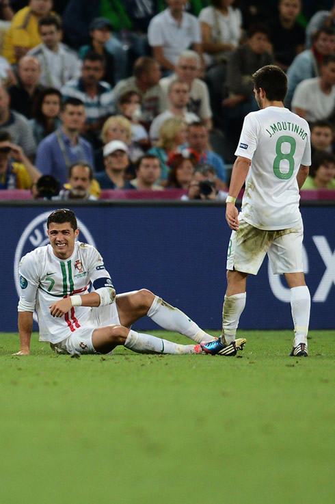 Cristiano Ronaldo hurt on the ground, as João Moutinho gets near him, in the EURO 2012 semi-finals between Portugal and Spain