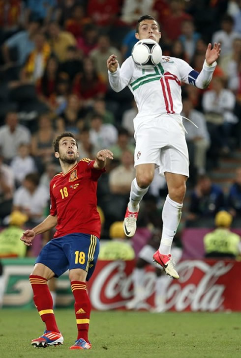 Cristiano Ronaldo great chest control in the air, with Jordi Alba mesmerized with his high jump, in the EURO 2012 semi-finals