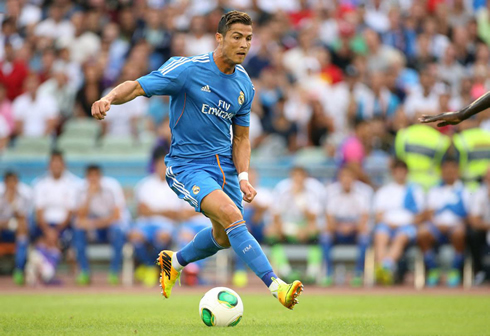 Cristiano Ronaldo jumping over the ball before taking on a defender, in Real Madrid pre-season tour 2013-2014