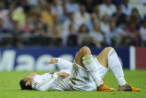 Cristiano Ronaldo on the ground, feeling some pain after taking a hit