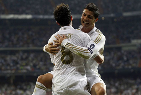 Cristiano Ronaldo looking happy in Kaká lap, after scoring a goal
