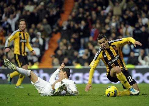 Cristiano Ronaldo goes down after colliding against a Zaragoza defender, in a Real Madrid game for La Liga in 2011-2012