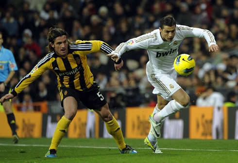 Cristiano Ronaldo tries to escape a defender and sprint in a Real Madrid game in 2012