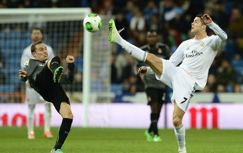 Cristiano Ronaldo raising his foot high in the air