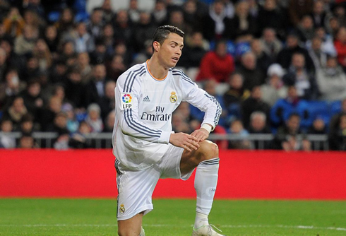 Cristiano Ronaldo with one knee down and about to stand up