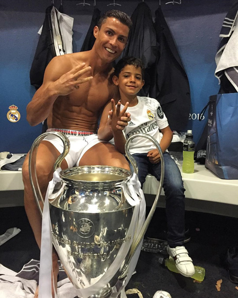 Cristiano Ronaldo and his son with the 2016 Champions League trophy