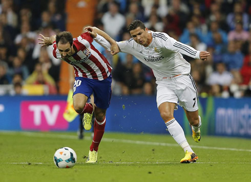 Cristiano Ronaldo fighting with Atletico Madrid Juanfran, as both sprint down the wing