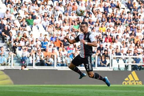 Cristiano Ronaldo hanging in the air to head a ball and score for Juventus