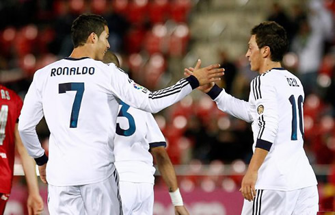 Real Madrid smiling and touching hands with Germany's international, Mesut Ozil, in La Liga 2012-2013