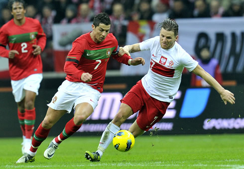Cristiano Ronaldo leaving a Polish defender behind him, as he dribbles in Poland vs Portugal, in 2012