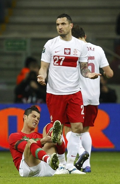 Cristiano Ronaldo on the ground complaining about a harsh tackle, in Poland vs Portugal in 2012
