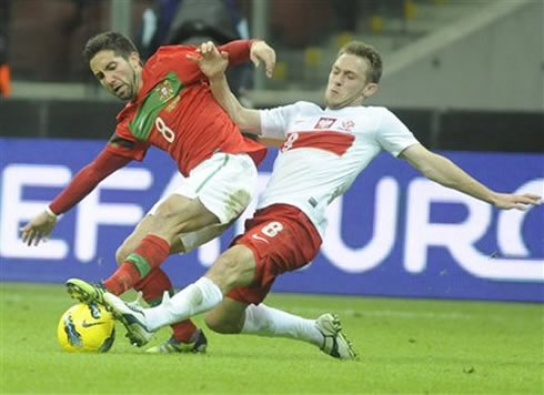 João Moutinho being tackled in Poland vs Portugal, in 2012