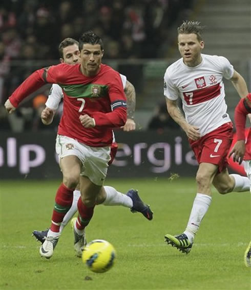 Cristiano Ronaldo running towards the ball in a match between Poland and Portugal, in the Polish National Stadium opening, in 2012