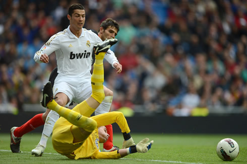 Cristiano Ronaldo tries to get past Sevilla goalkeeper in a La Liga game in 2012