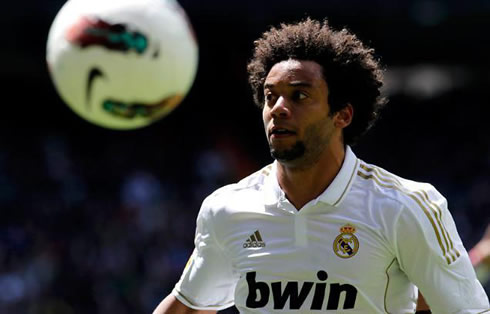 Marcelo making a scary face in a soccer match for Real Madrid in 2012, with his hair all pulled up