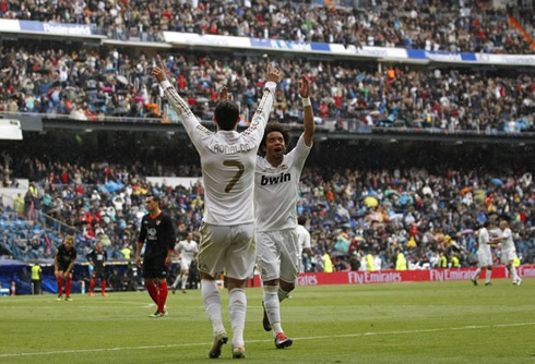 Cristiano Ronaldo and Marcelo raising their hands up, in Real Madrid goal celebrations in 2012