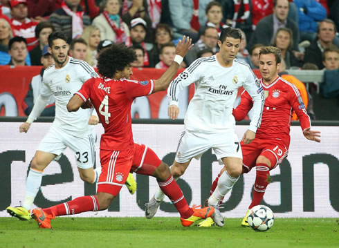 Cristiano Ronaldo being tackled and fouled by Dante, in Bayern Munich vs Real Madrid