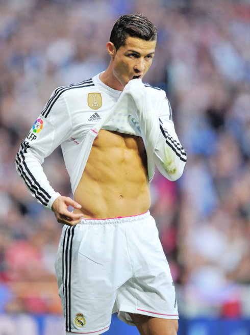 Cristiano Ronaldo pulling his shirt up and showing his abs