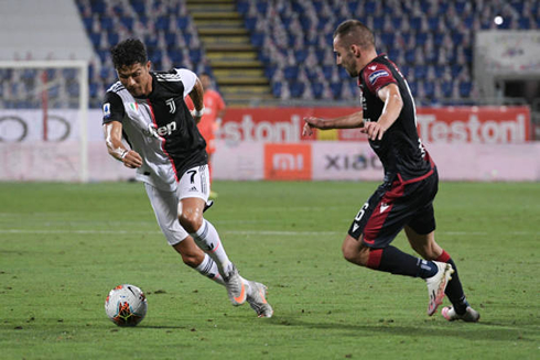 Cristiano Ronaldo changes his direction on the pitch as he tries to get past a defender