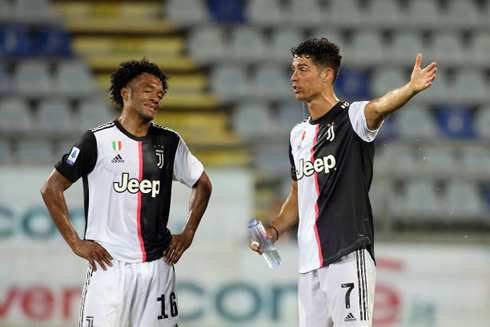 Cuadrado and Ronaldo having a talk during a water break