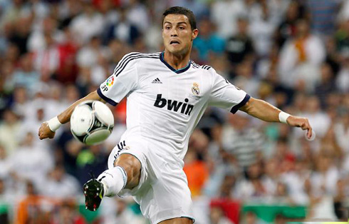 Cristiano Ronaldo stretching his right leg to reach the ball, in a game for Real Madrid in August 2012
