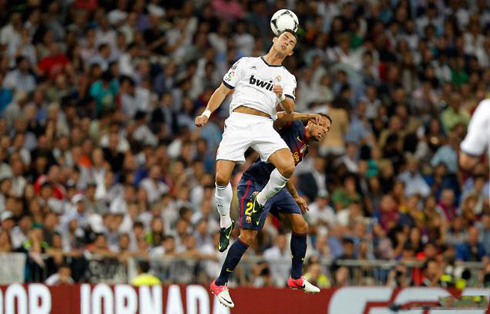 Cristiano Ronaldo jumping high in the air and heading the ball in a Real Madrid vs Barcelona game in 2012-2013
