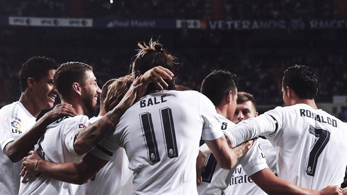 Cristiano Ronaldo hugging his teammates, with Bale and James in the middle