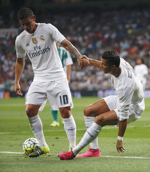 James Rodríguez helping Ronaldo standing up