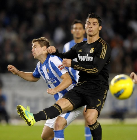 Cristiano Ronaldo shoves a defender after shooting the ball