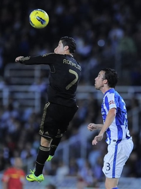 Cristiano Ronaldo heads the ball after reaching the ball from a high jump