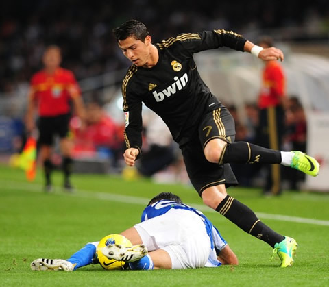 Cristiano Ronaldo gets tackled by a defender, in the Spanish League