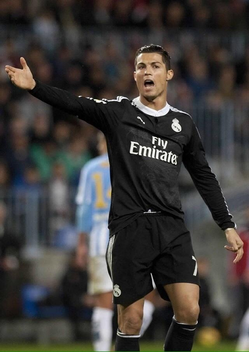 Cristiano Ronaldo raising his right arm and complaining about something