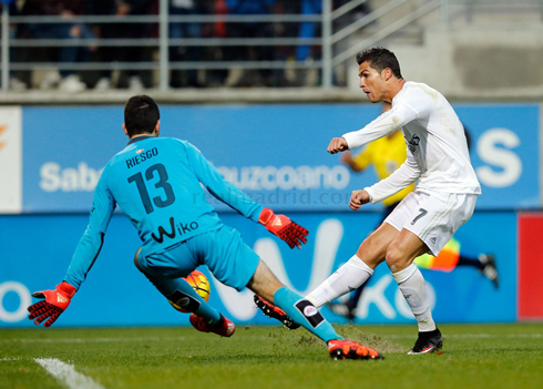 Cristiano Ronaldo trying to score from close range, as the goalkeeper blocks his shot