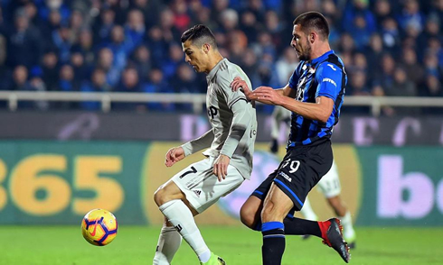 Cristiano Ronaldo holding a defender on his back in a cup game for Juventus