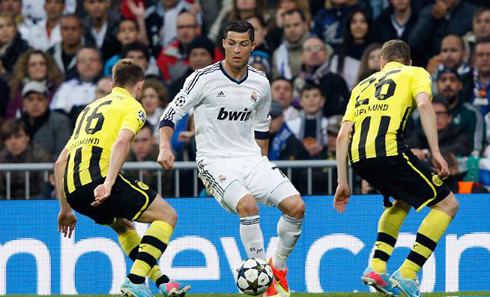 Cristiano Ronaldo trying to get past two Borussia Dortmund defenders, during the UEFA Champions League semi-finals ties, in 2013