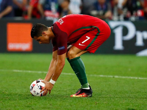 Cristiano Ronaldo placing the ball on the penalty-mark to take his penalty