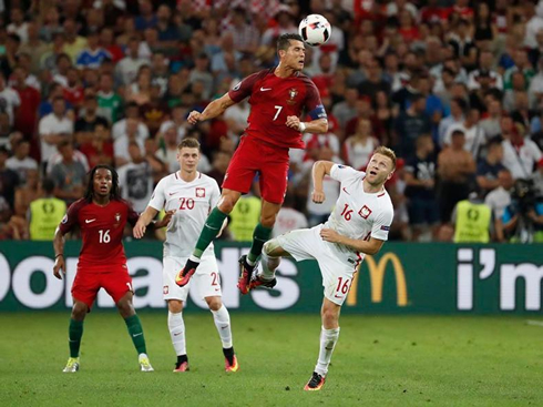 Cristiano Ronaldo heading the ball high in the air, in Portugal vs Poland